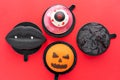 Black lips with vampire fangs, a torn eye, an ominous pumpkin and black mountain. Halloween scary mousse cake with