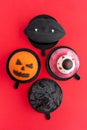 Black lips with vampire fangs, a torn eye, an ominous pumpkin and black mountain. Halloween scary mousse cake with