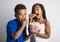 Black little boy and girl watching movie with pop corn Royalty Free Stock Photo