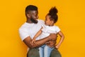 Black little girl and handsome dad looking at each other Royalty Free Stock Photo