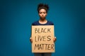 African american woman holding placard with BLM text
