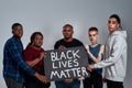 Black Lives Matter banner in multiracial people hands