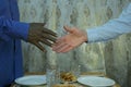 Black lives matter. Meeting at the cafe. Close up photo of a handshake between afroamerican and european hands Royalty Free Stock Photo