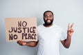 Black lives matter. Photo of cheerful dark skin afroamerican protester hold placard against black citizens lawlessness