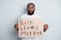 Black lives matter. Photo of serious disappointed dark skin african protester placard community against black citizens