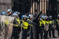 Black Lives Matter protest during lockdown coronavirus pandemic. Young protester in mask holding fist in the air in front of