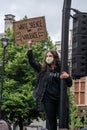 UK, London, 6/6/2020 - A Black Lives Matter protester whos climbed on a traffic light to wave an anti-racism placard