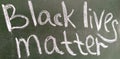 Black lives matter written in chalk on blackboard