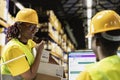 Black logistics workers team handling cargo tracking on pc software Royalty Free Stock Photo