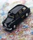 Black London taxi cab on map of London Royalty Free Stock Photo