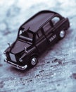 Black London taxi cab on street map of London Royalty Free Stock Photo