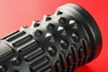 Black lumpy foam massage roller on red background. For the mechanical and reflex effects on tissues and organs Royalty Free Stock Photo