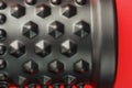 Black lumpy foam massage roller on red background. For the mechanical and reflex effects on tissues and organs Royalty Free Stock Photo