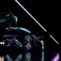 Black Luxury Futuristic Sports Car Drives on Glossy Black Road in Neon Light.