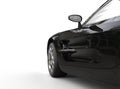 Black luxury sports car on white background - door close-up.