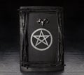 Black magic book with pentagram symbol