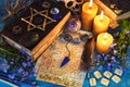 Black magic book of spells, runes and candles on ritual witch table. Royalty Free Stock Photo