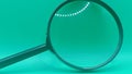 a black magnifying glass  on a solid teal background. Royalty Free Stock Photo