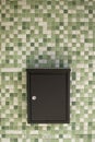 Black mail box with vintage green white tile wall Royalty Free Stock Photo