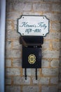 A black mailbox and a museum green and tan sign Royalty Free Stock Photo