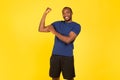 Black Male Athlete Showing Biceps Posing After Workout, Yellow Background Royalty Free Stock Photo