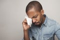 Scared black male cries, being scared of something, poses against white studio background, expresses anxiety and fear. Royalty Free Stock Photo