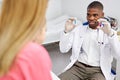 african male doctor have a nice talk with kid girl, showing colourful capsules