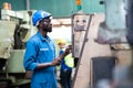 Black Male Engineer Working on machine in Factory. black man engineer checking Quality control the condition of the machine. Royalty Free Stock Photo