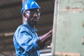 Black Male Engineer Working on machine in Factory. black man engineer checking Quality control the condition of the machine.