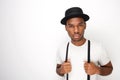 Black male fashion model posing with hat and suspenders against white background Royalty Free Stock Photo