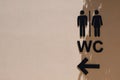 Black male and female public restroom sign with right direction on the wall with shadows.Toilets man and woman icon. WC