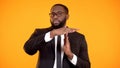 Black male in formalwear showing time out sign, interrupt negotiations, vacation Royalty Free Stock Photo