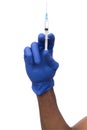 Black male hand in blue glove holding a plastic syringe Royalty Free Stock Photo