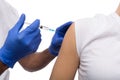 Black male hand in blue gloves holding a plastic syringe Royalty Free Stock Photo