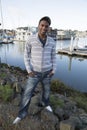 Black male model standing at the waterfront casual dress smiling Royalty Free Stock Photo