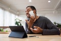 Black male shaving his beard and using digital tablet pretend to be mirror Royalty Free Stock Photo