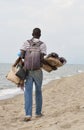 Black male shopkeeper offer his goods on a sandy