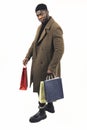 black male shopper with bags in his hands white background - full shot