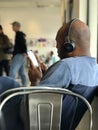 African American Male with Headphones and Cell Phone