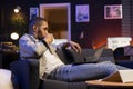 Black male trader monitoring stock market real time changes on laptop