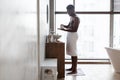 Black Man Applying Shaving Foam On Hand Standing In Bathroom Royalty Free Stock Photo