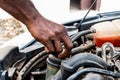Black man as Auto mechanic working in garage near car engine. Repair service and transport concept. Hands of African American car Royalty Free Stock Photo