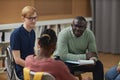 Black man as male psychologist talking to group teenagers in therapy session Royalty Free Stock Photo