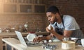 Black man baking pastry and looking recipe in laptop Royalty Free Stock Photo