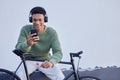 Black man, bicycle and headphones for travel, social media update and 5g networking on nature or sky mockup for