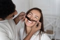 Black man and caucasian woman in white clothes, couple fool around. Guy plays with girl hair making her mustache. Joy and Royalty Free Stock Photo