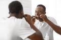 Black Man Cleaning Teeth With Floss In Bathroom At Home Royalty Free Stock Photo