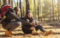 Black man comforting his injured woman, hiking together