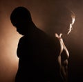 Black man, dark studio and muscle silhouette reflection with thinking, depression and mental health with shadow. Man