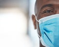 Black man doctor with covid face mask face portrait for African healthcare insurance. Sad, fear and risk in eye of a Royalty Free Stock Photo